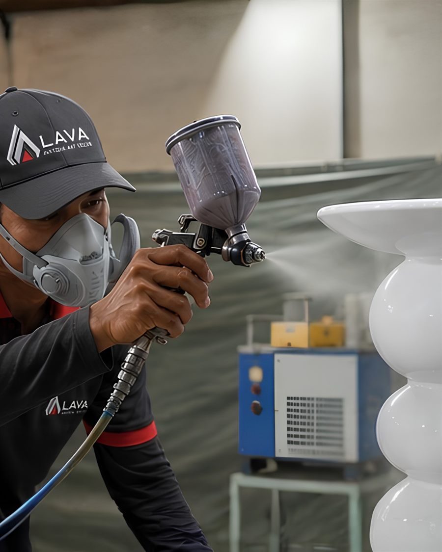 LAVA technician spray-finishing a sculptural white piece